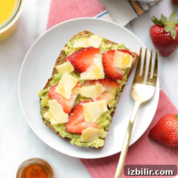 A plate of toast with strawberries and guacamole.