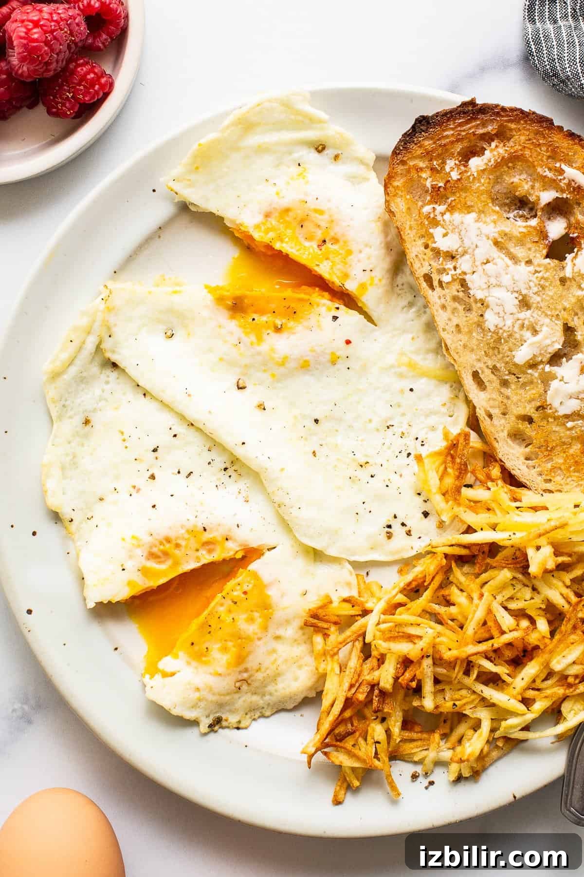 Over medium eggs on a plate with toast.