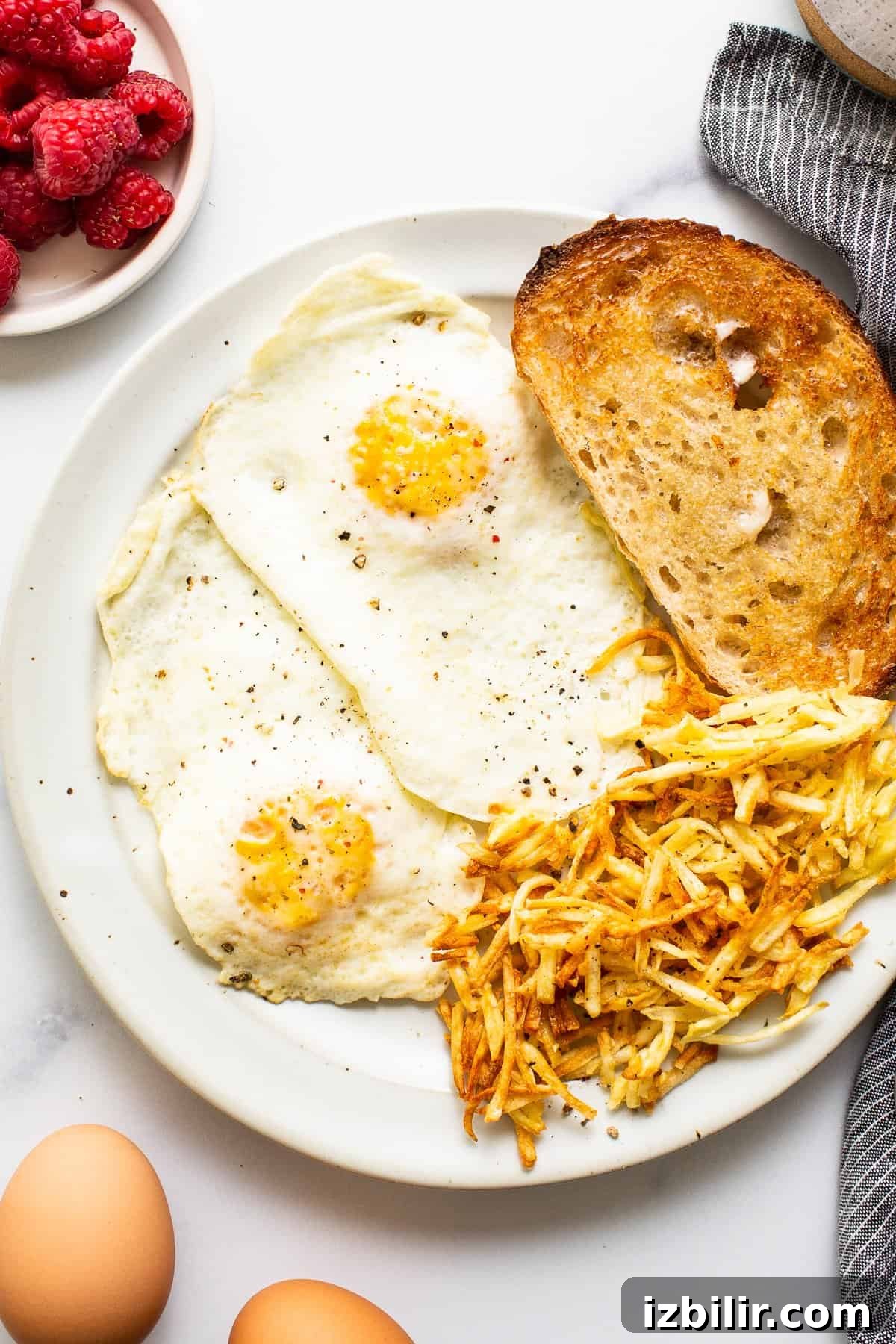 Over medium eggs on a plate with toast.