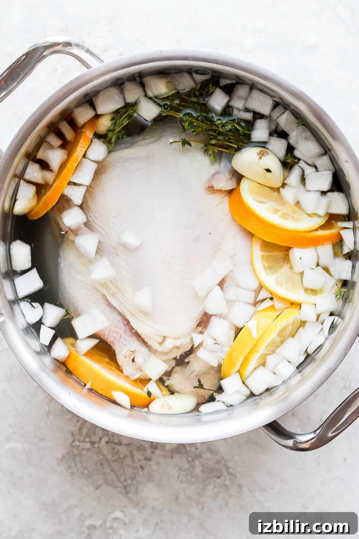 Whole chicken brine Chicken brine and a whole chicken in a pot.