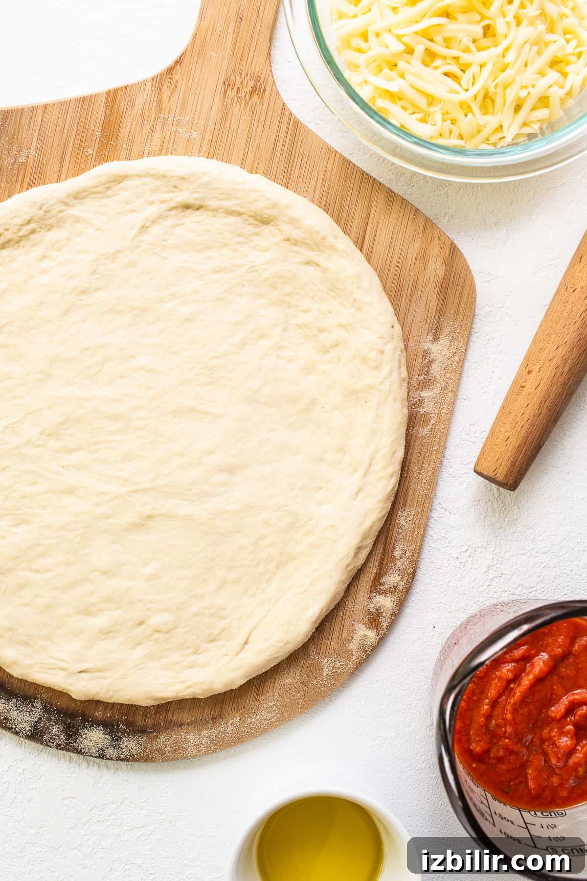 pizza crust on cutting board.