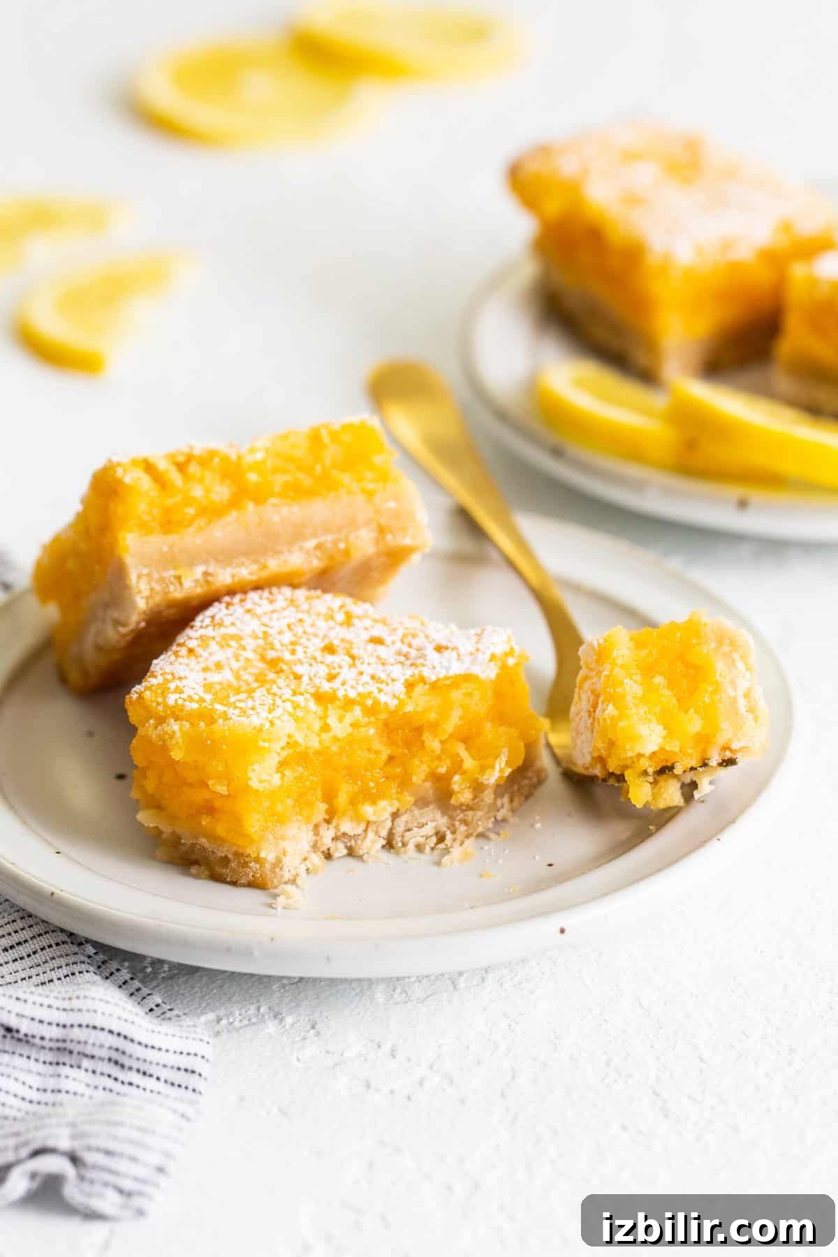 Classic lemon bars lemon bars on plate with fork.