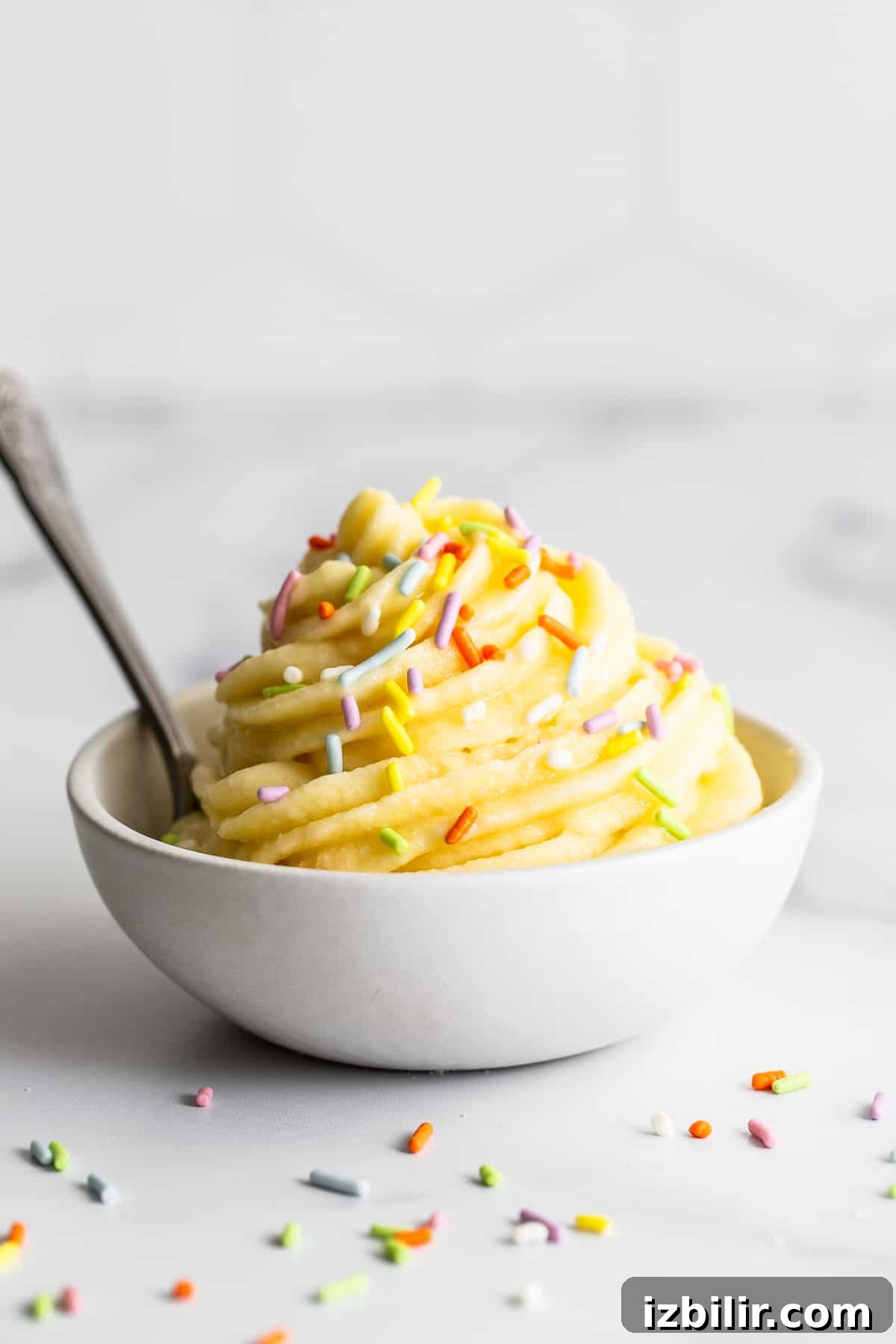 Dole Whip in a bowl topped with sprinkles.