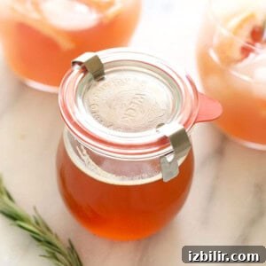 Refreshing Summer Punch Recipe for Backyard Parties 2 honey simple syrup in jar.