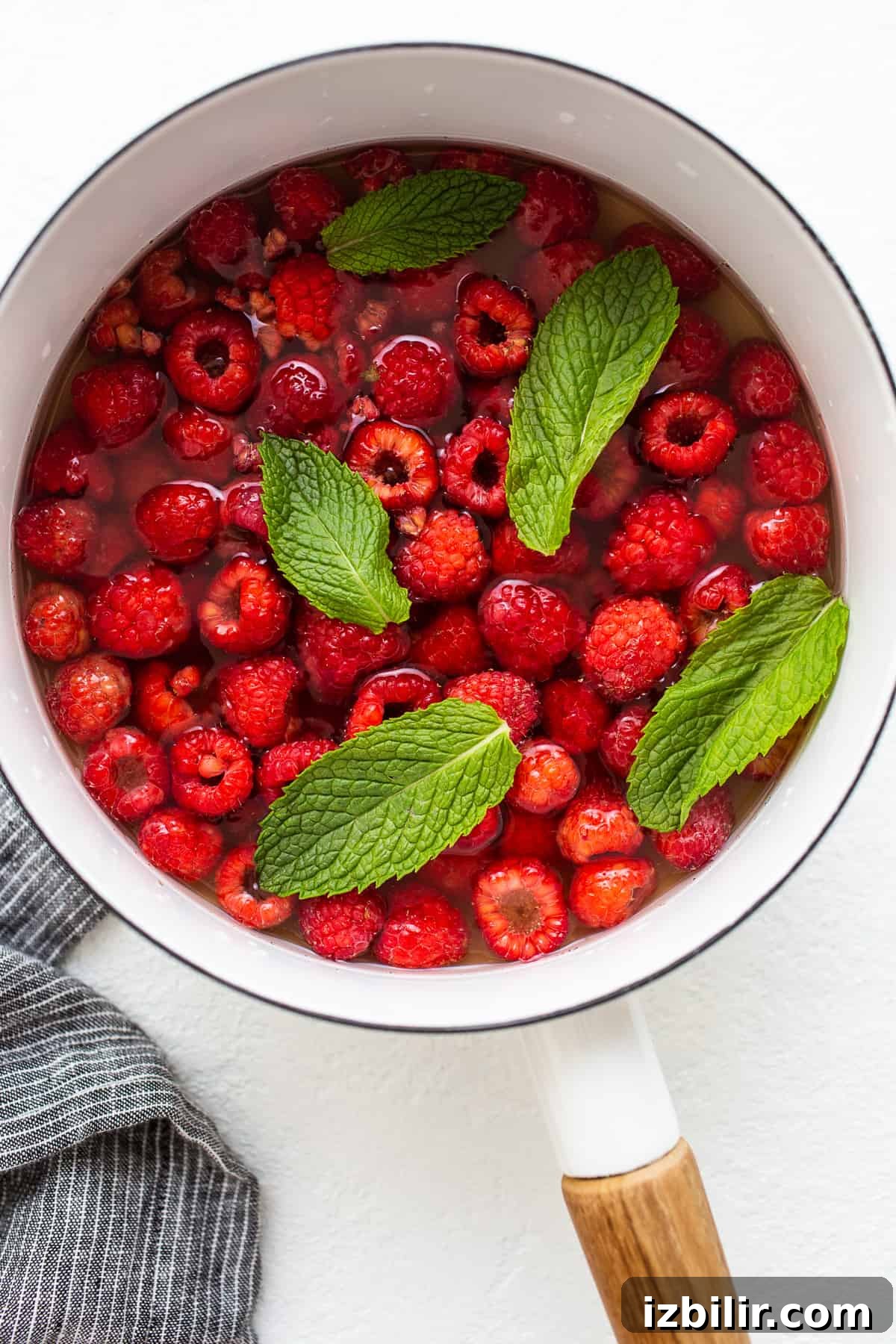 Raspberries simmering to make syrup raspberries simmering in water and honey.