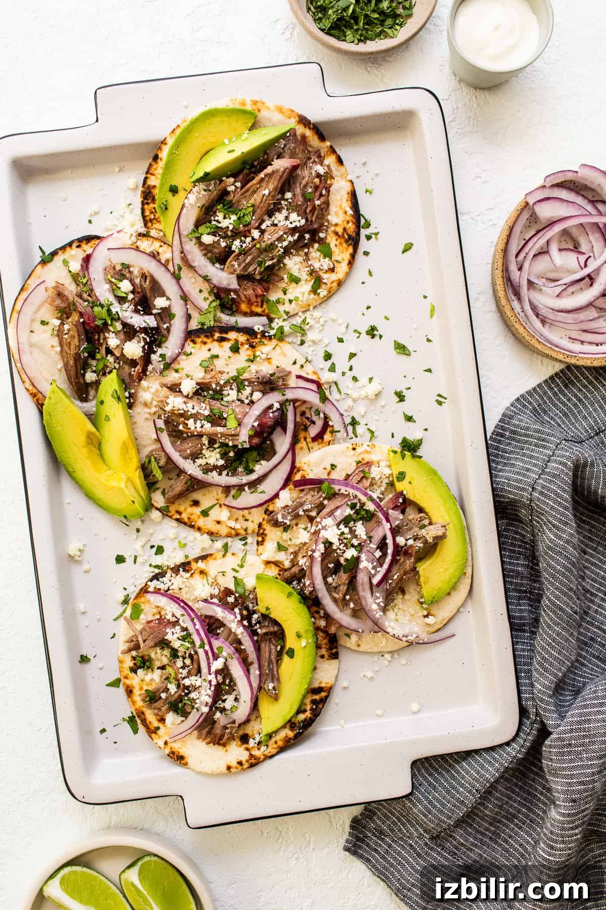 These smoked pulled pork tacos are made with our incredible, fall-off-the-bone smoked pork shoulder and all the best toppings. shredded pork tacos with avocado.