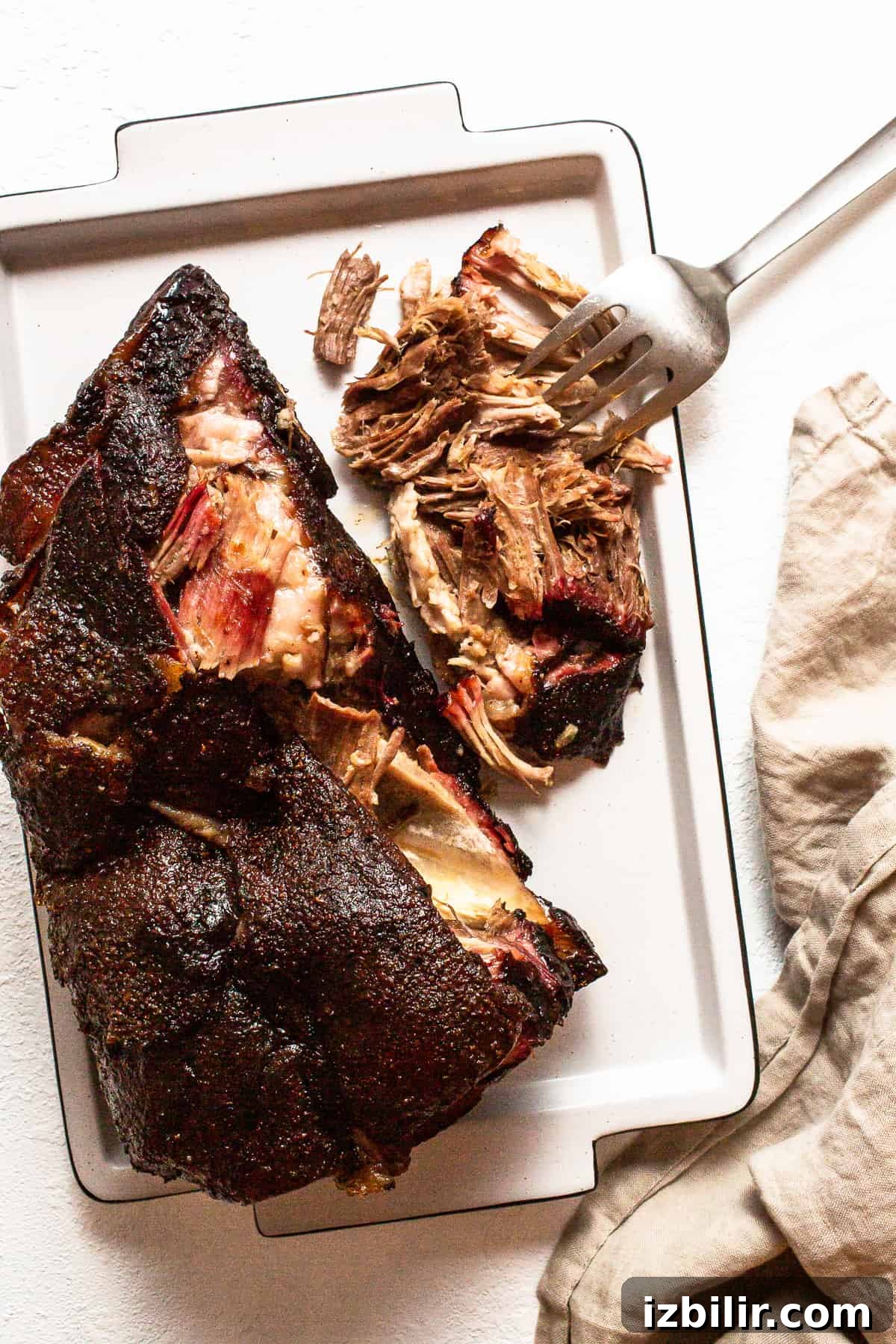 Smoked Pulled Pork Tacos Recipe with Chipotle Lime Slaw 2 Finished pork shoulder on a tray after resting.