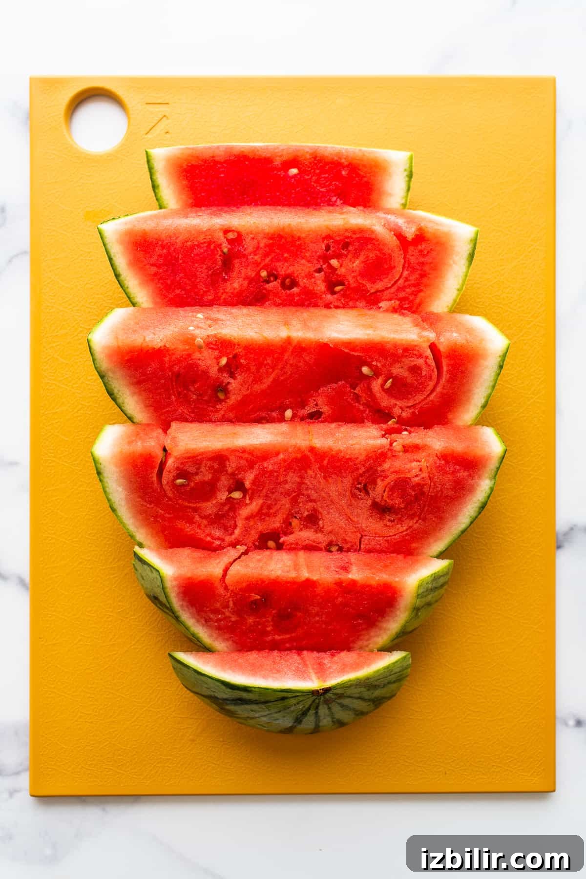 Sliced watermelon on cutting board
