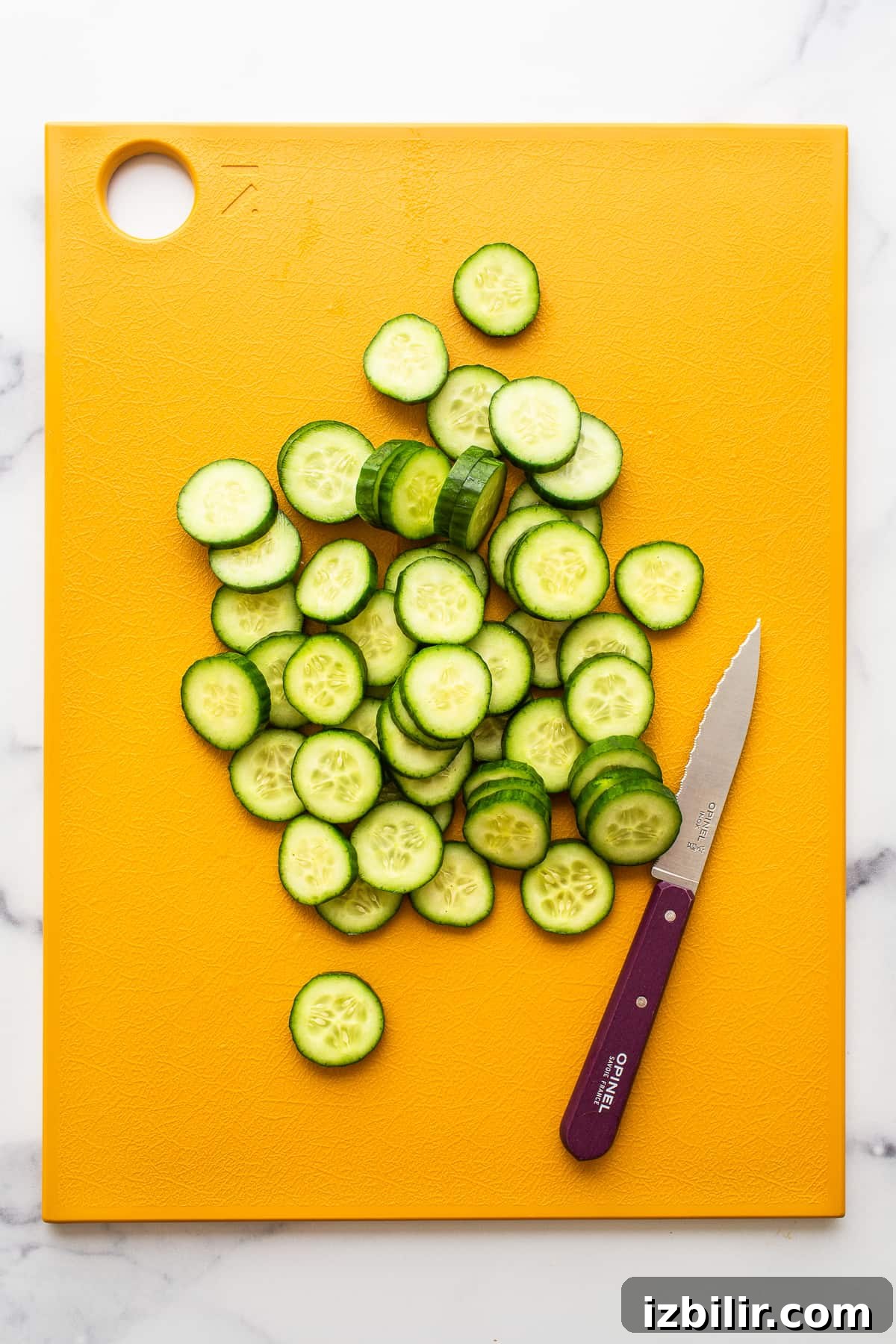 Sliced cucumber on cutting board