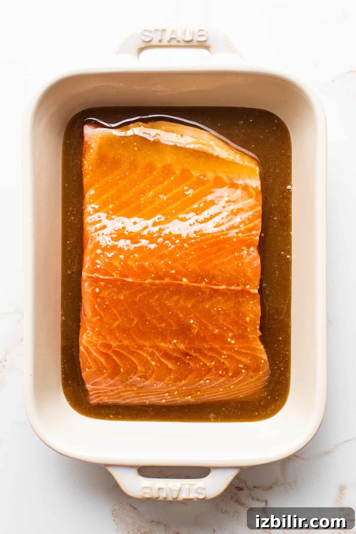 Smoked Salmon with Maple Mustard Glaze 3 A salmon filet marinating in a dish.