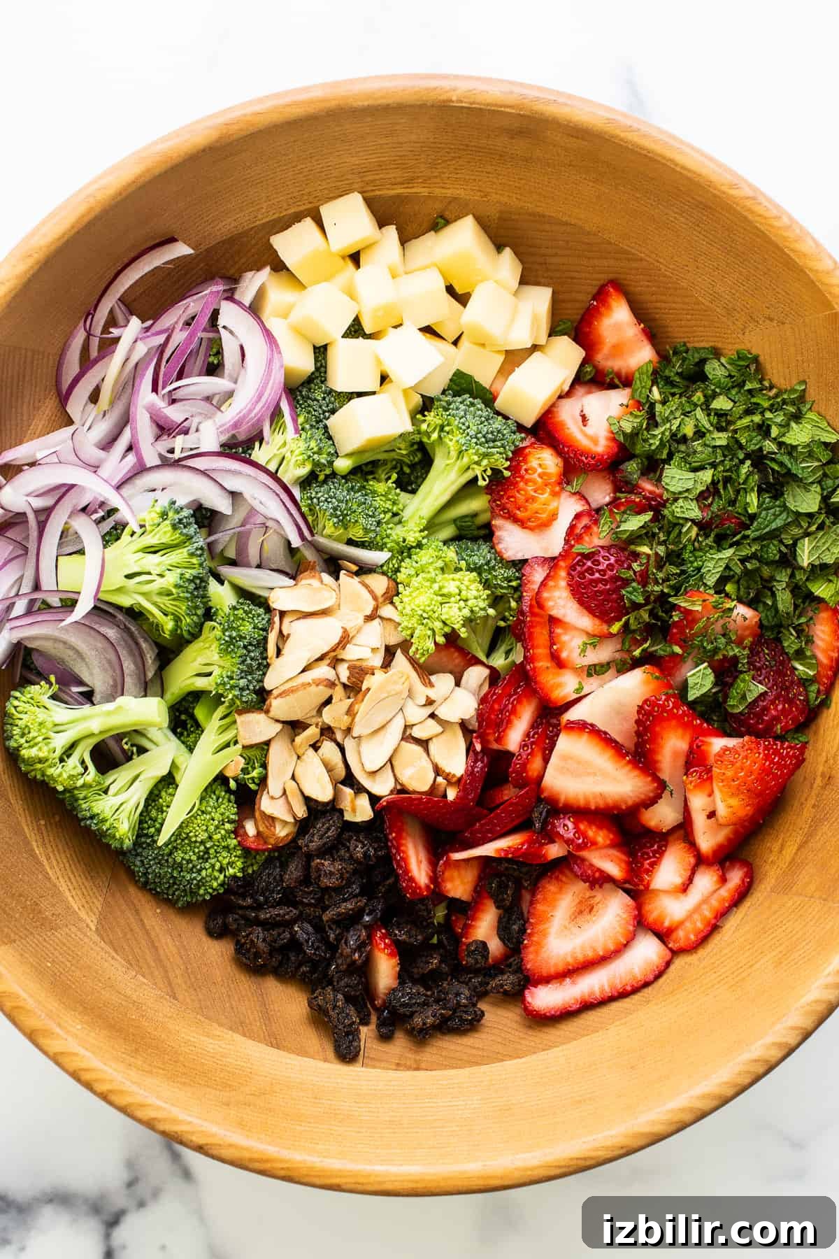 Fresh Strawberry Broccoli Salad Recipe with Poppy Seed Dressing 4 Ingredients for strawberry broccoli salad in a large wooden bowl.