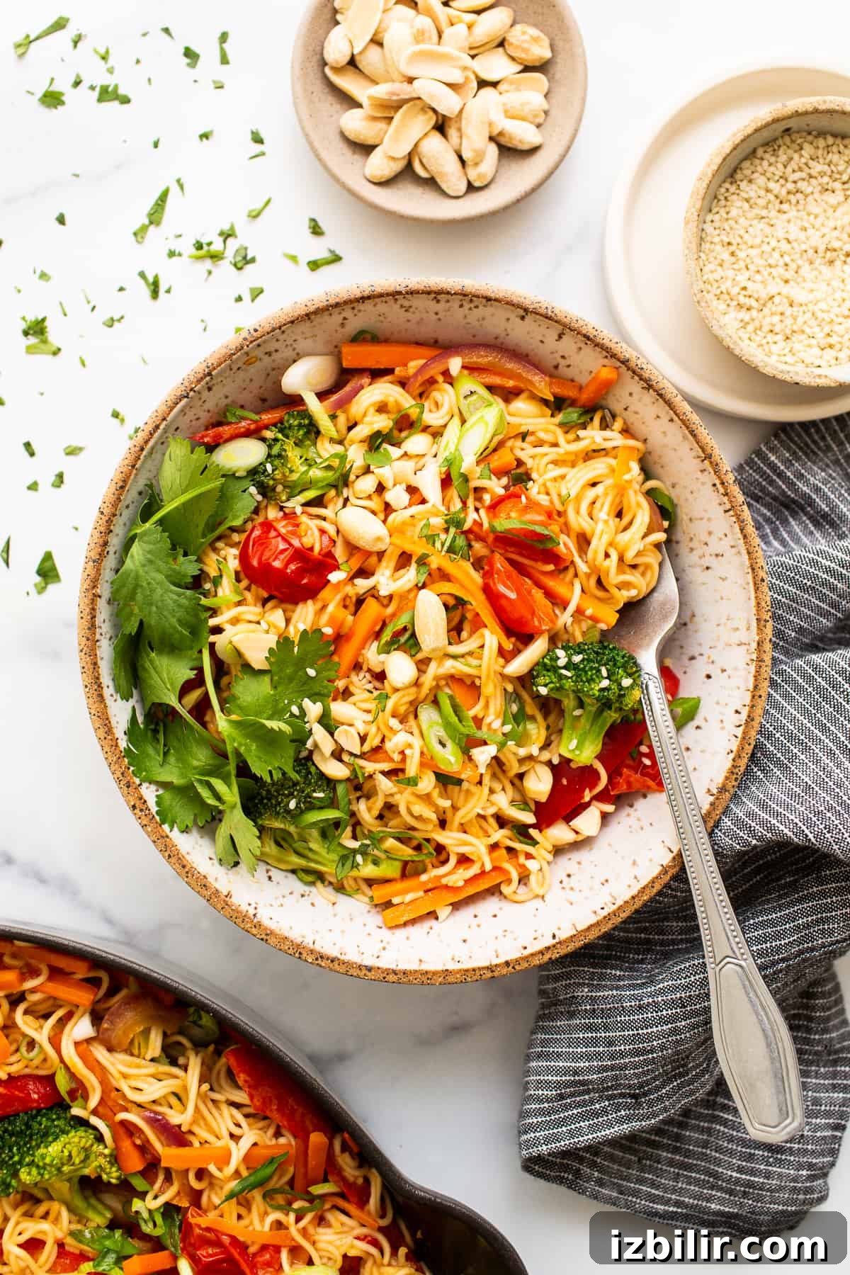 Peanut butter noodles with veggies in bowl.