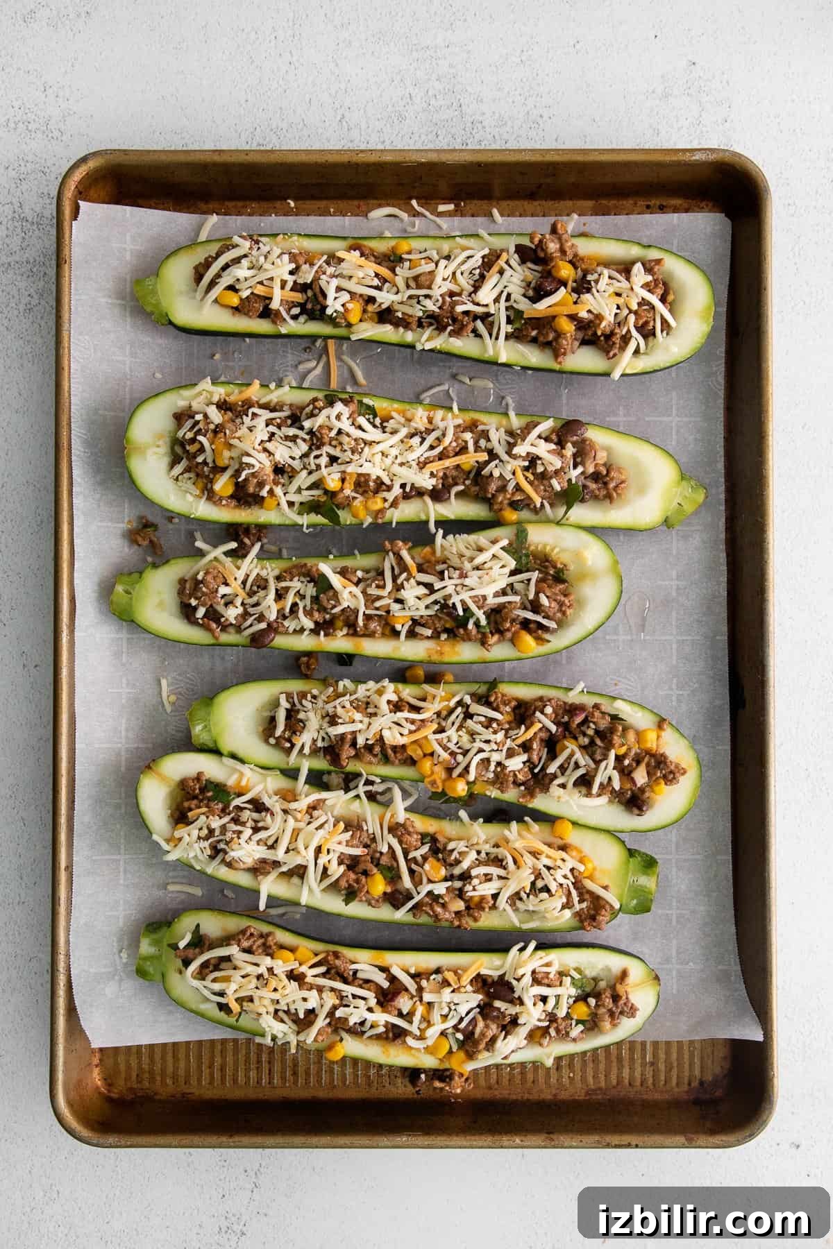 stuffed zucchini on baking sheet