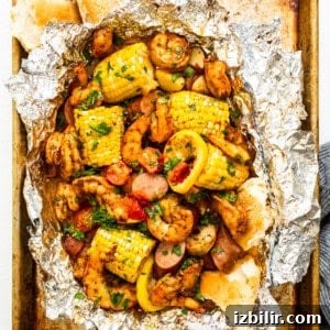 Shrimp foil packet full of veggies and shrimp.
