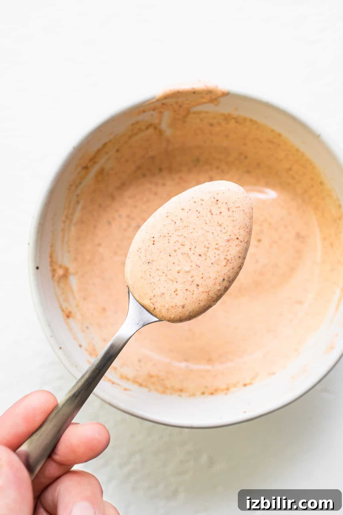 Burger sauce on a spoon.