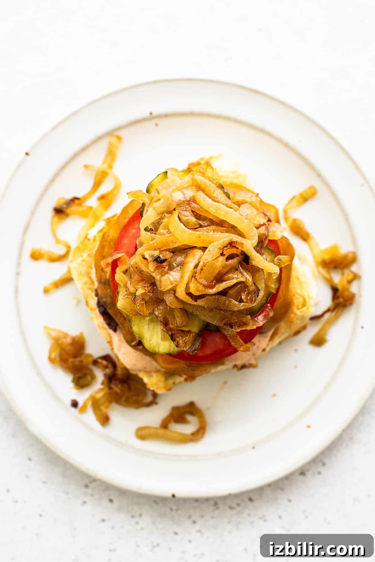 Homemade burgers topped with caramelized onions.