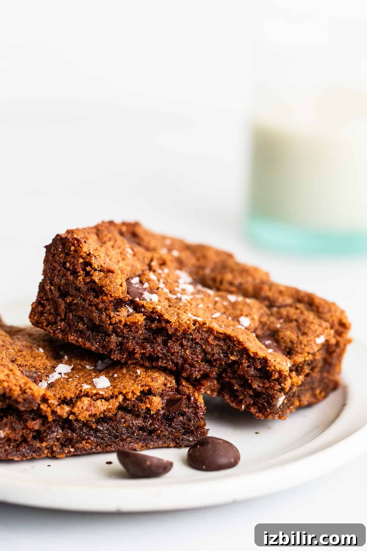Make our flourless almond butter chocolate chip cookie bars for a delicious treat made with wholesome ingredients! cookie bar recipe on plate.