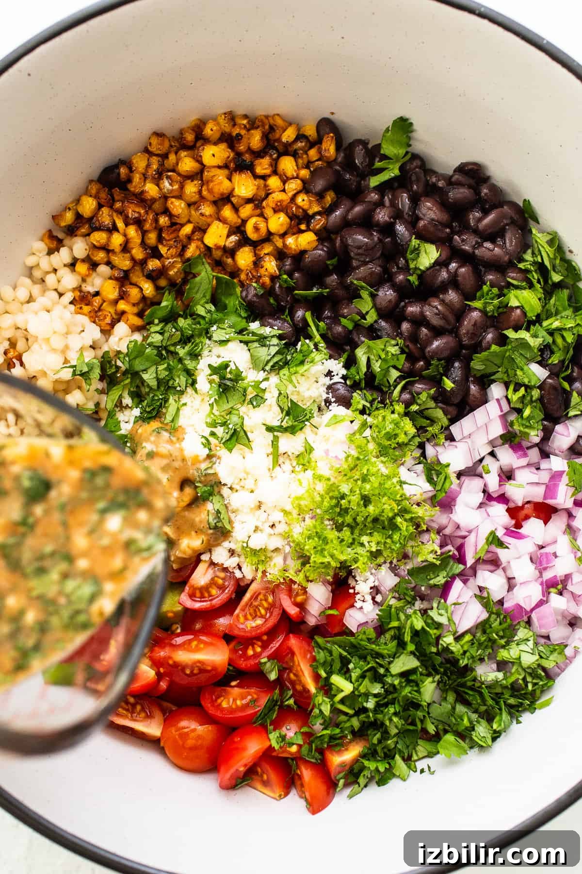 pouring dressing on salad.