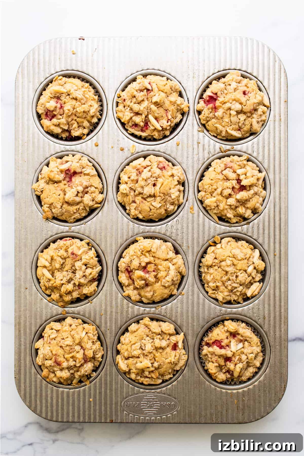 raspberry muffins in muffin tin.