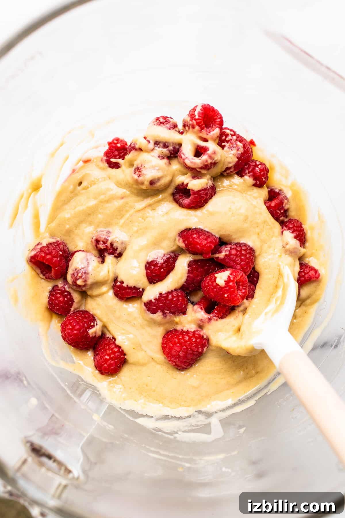 raspberry muffin batter in bowl.