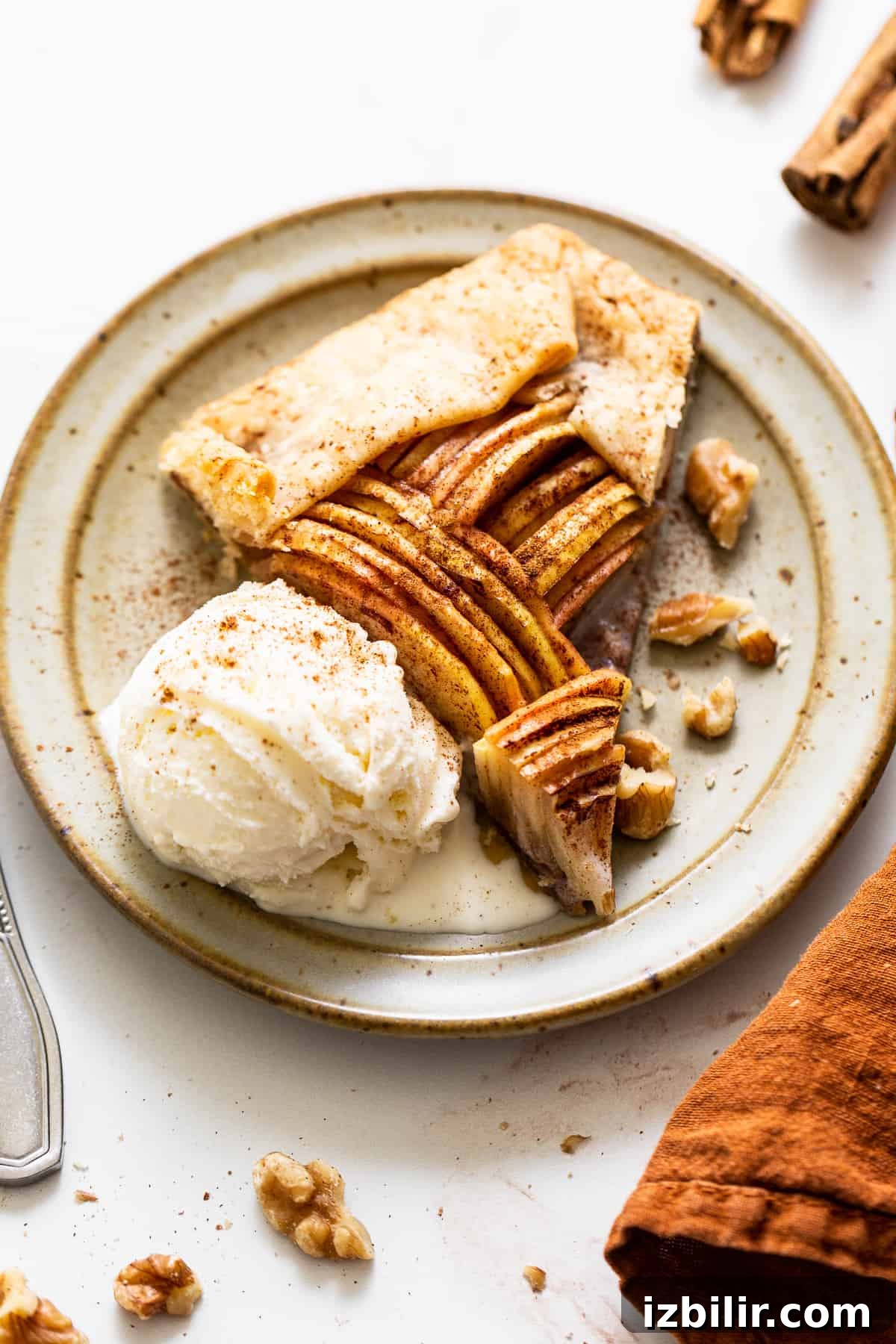 This gorgeous brown butter apple galette is made with pie crust, Honeycrisp apples, brown sugar, cinnamon, and brown butter. A slice of apple galette with ice cream.
