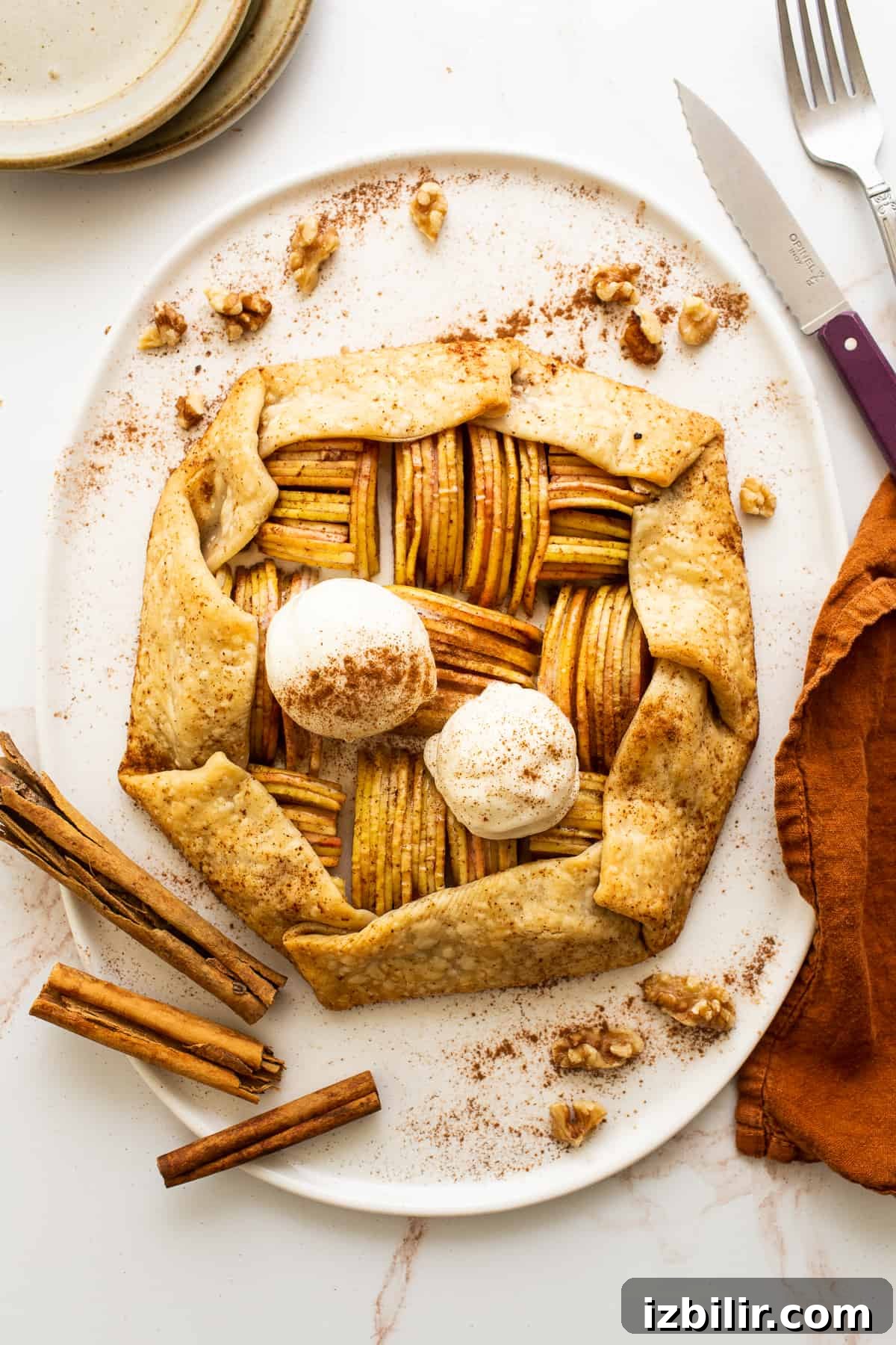 Serve warm with vanilla ice cream. Apple galette with ice cream on platter.