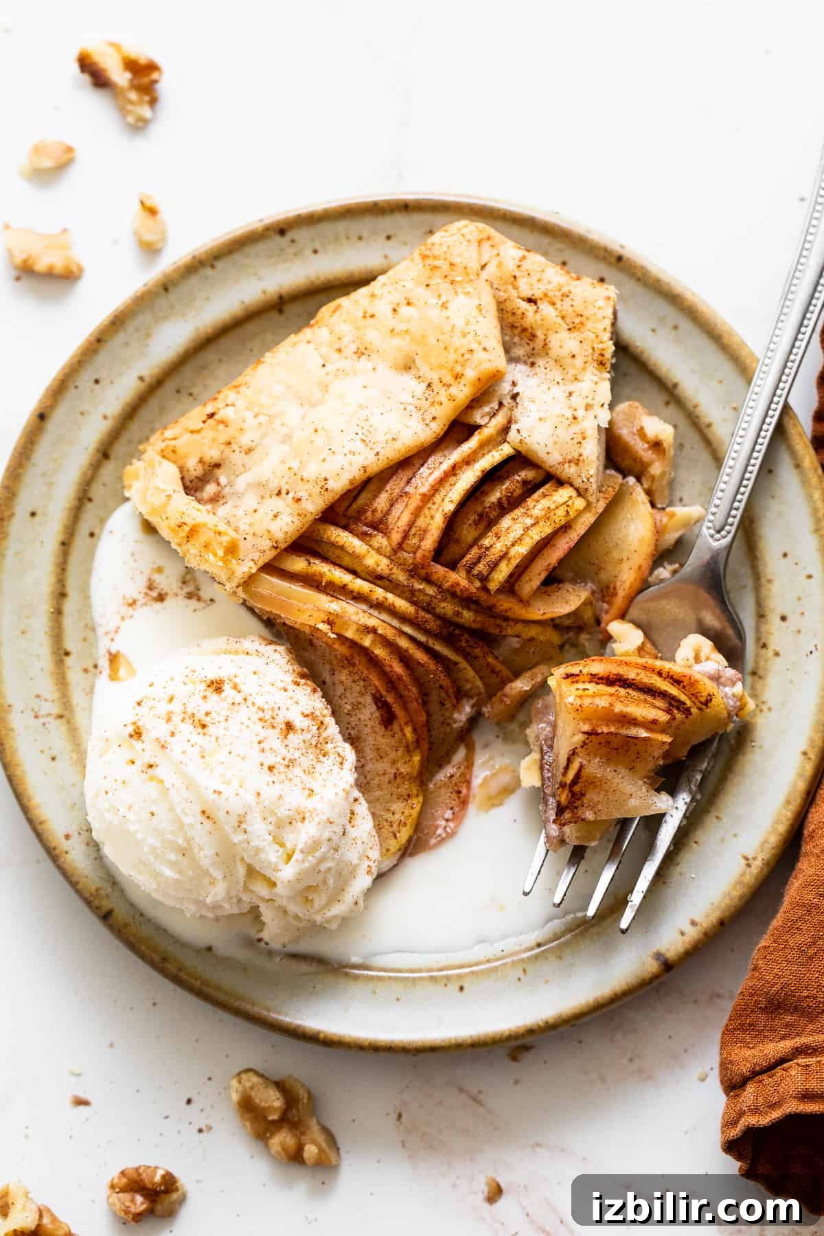 Sliced apple galette ready to serve. Sliced apple galette on plate.
