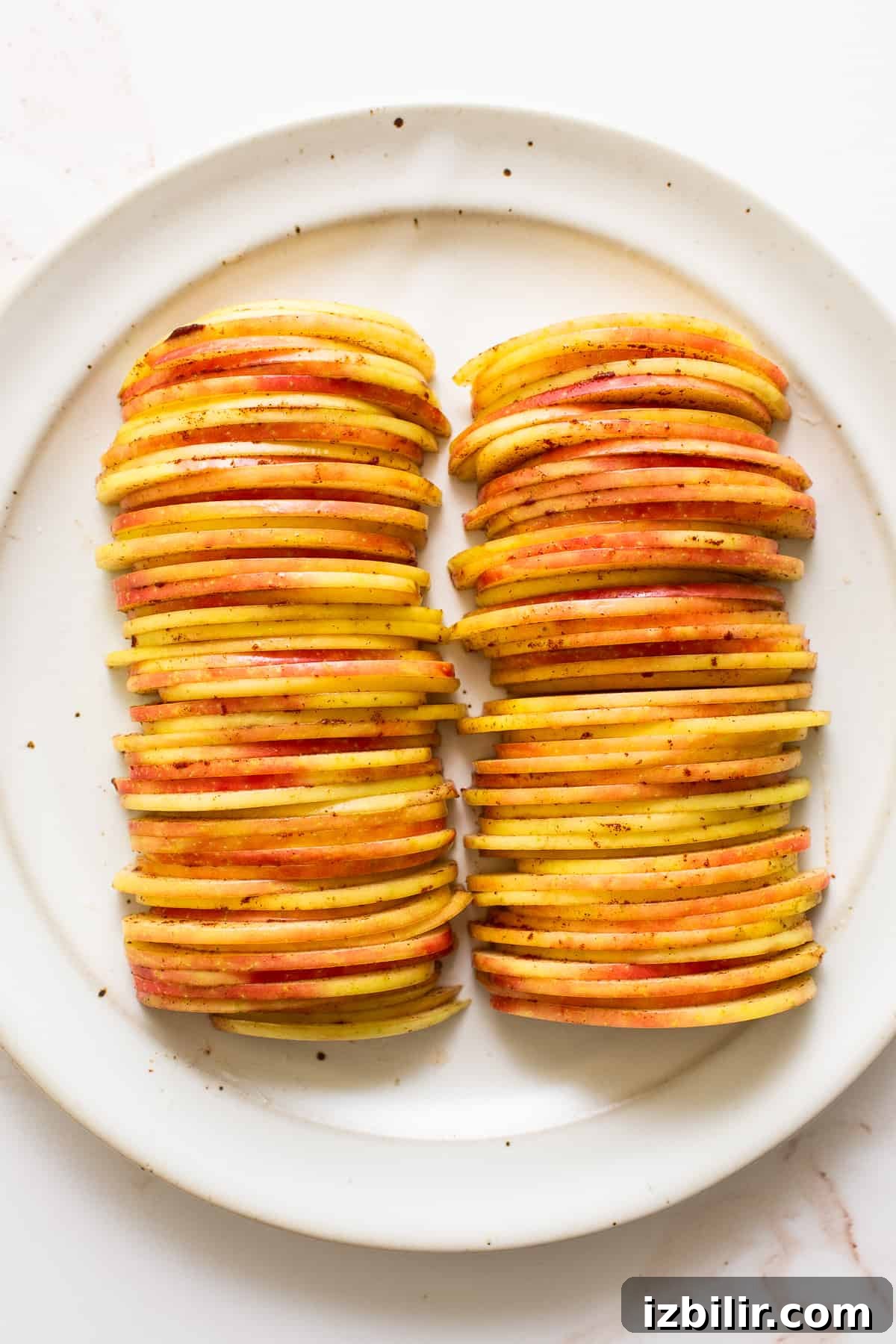Sliced Honeycrisp apples ready for the galette. Sliced apples on a plate.