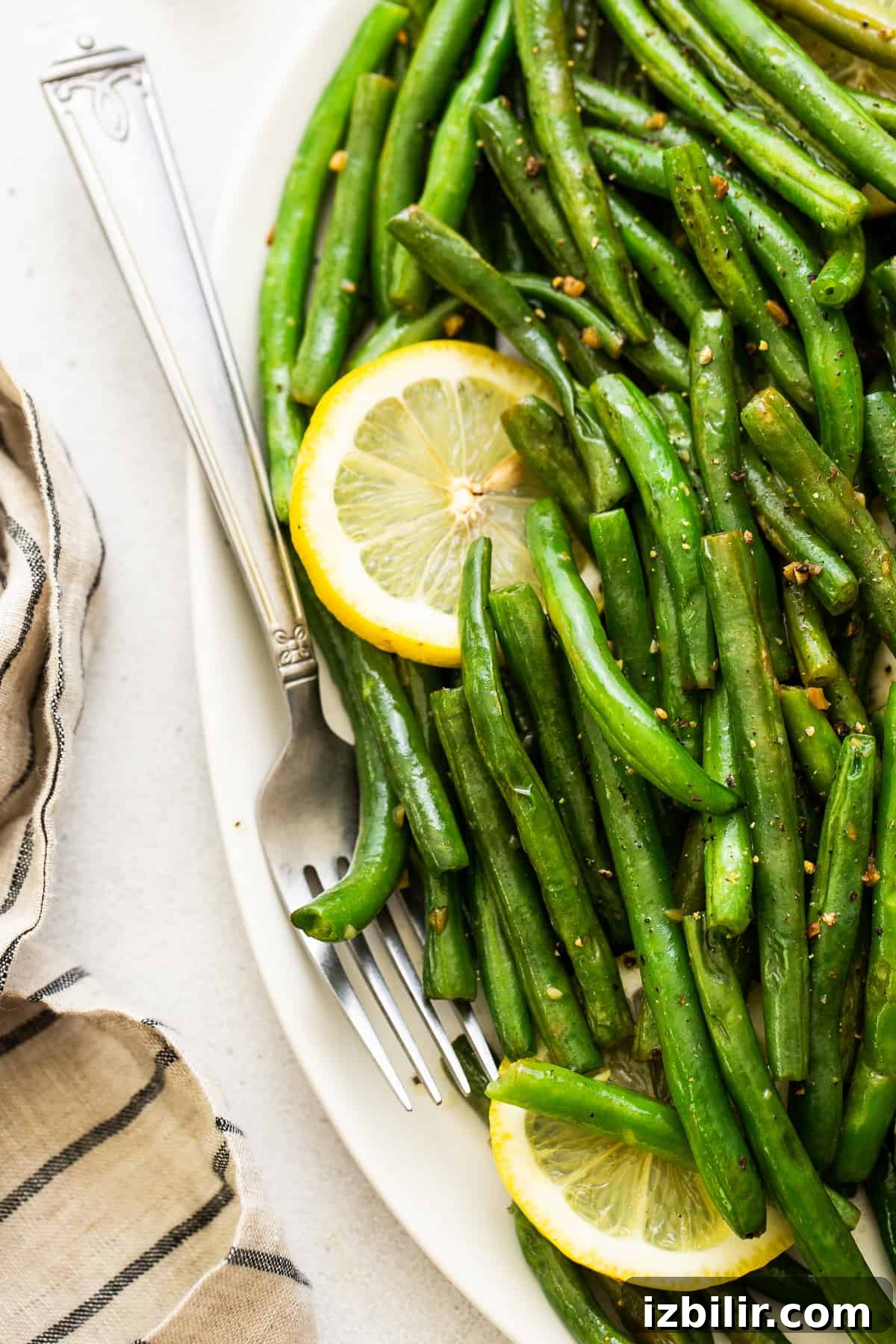 cooked green beans with lemon and garlic on platter.