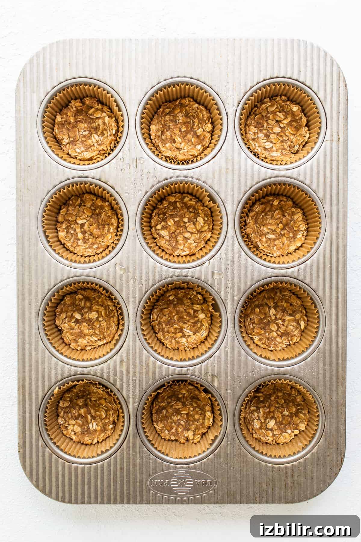 Mini apple crisps are a fun way to serve traditional apple crisps but in a single serving. crisp topping in muffin tin.