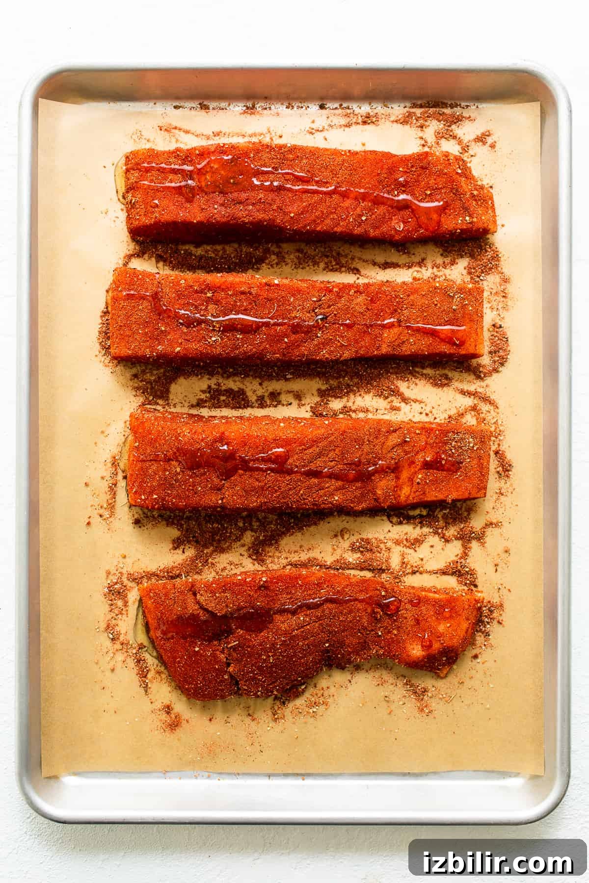 Salmon filets with seasoning and oil.