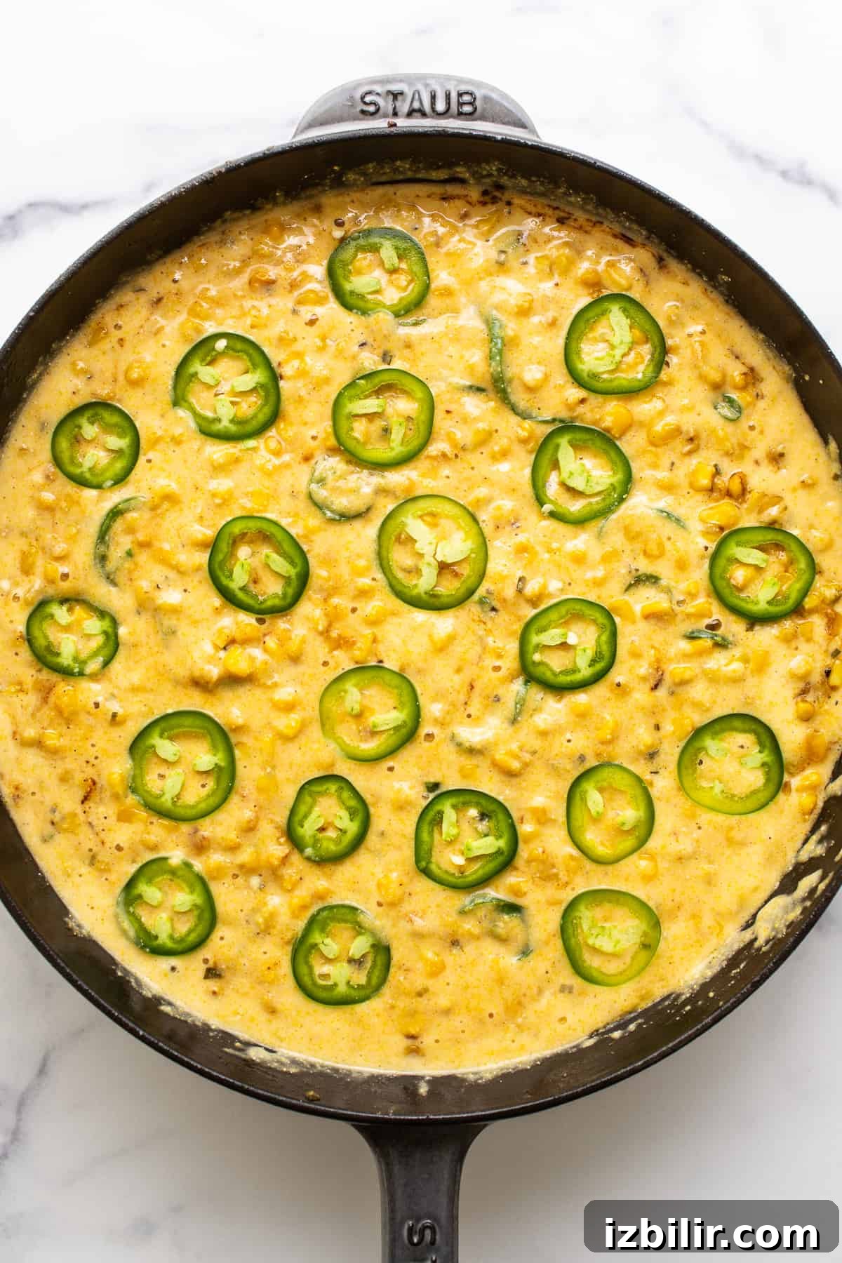 Jalapeño corn pudding in a cast iron skillet ready to be baked. Jalapeno corn pudding in a cast iron skillet ready to be baked.