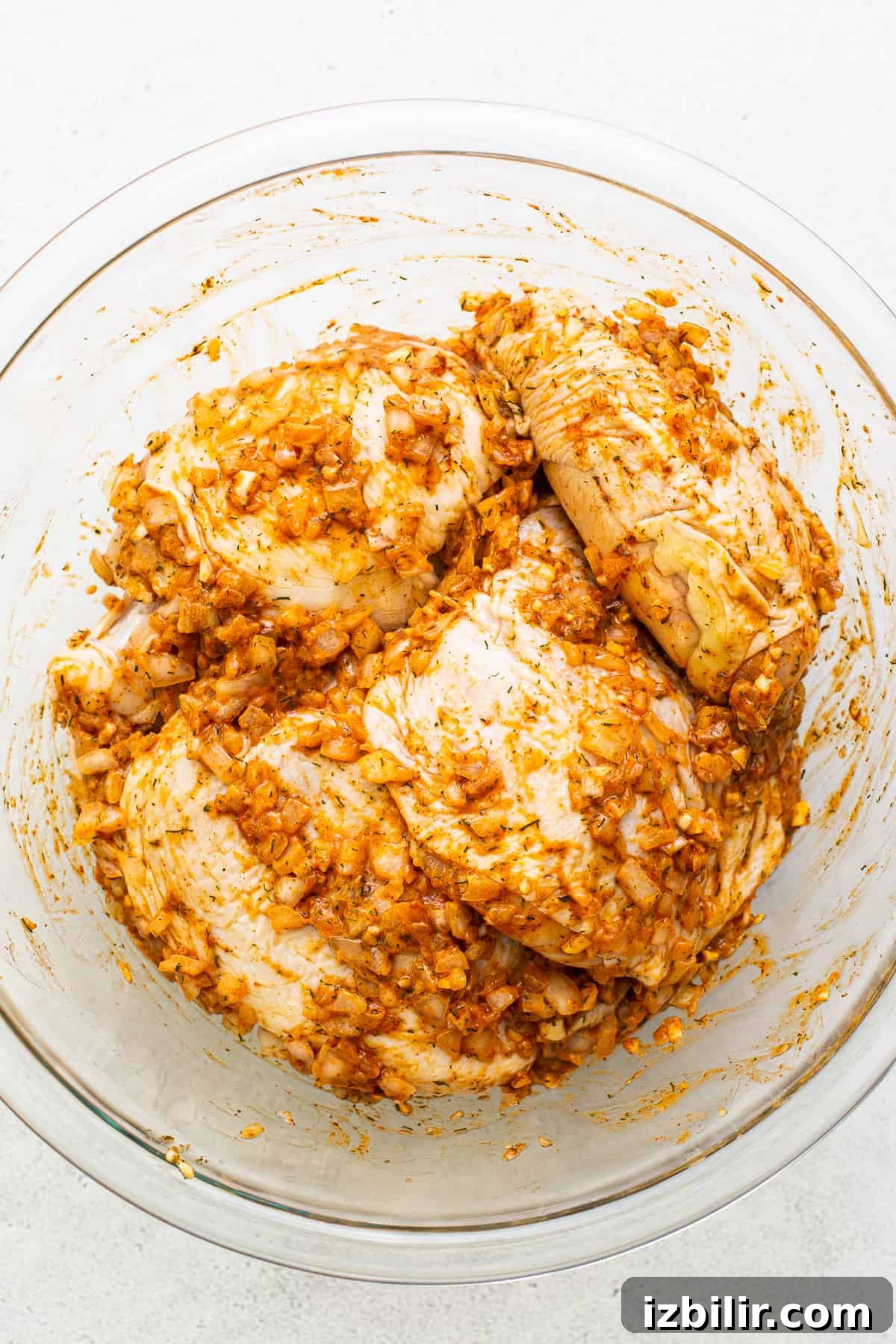 Marinated chicken thighs Chicken thighs marinating in a bowl.