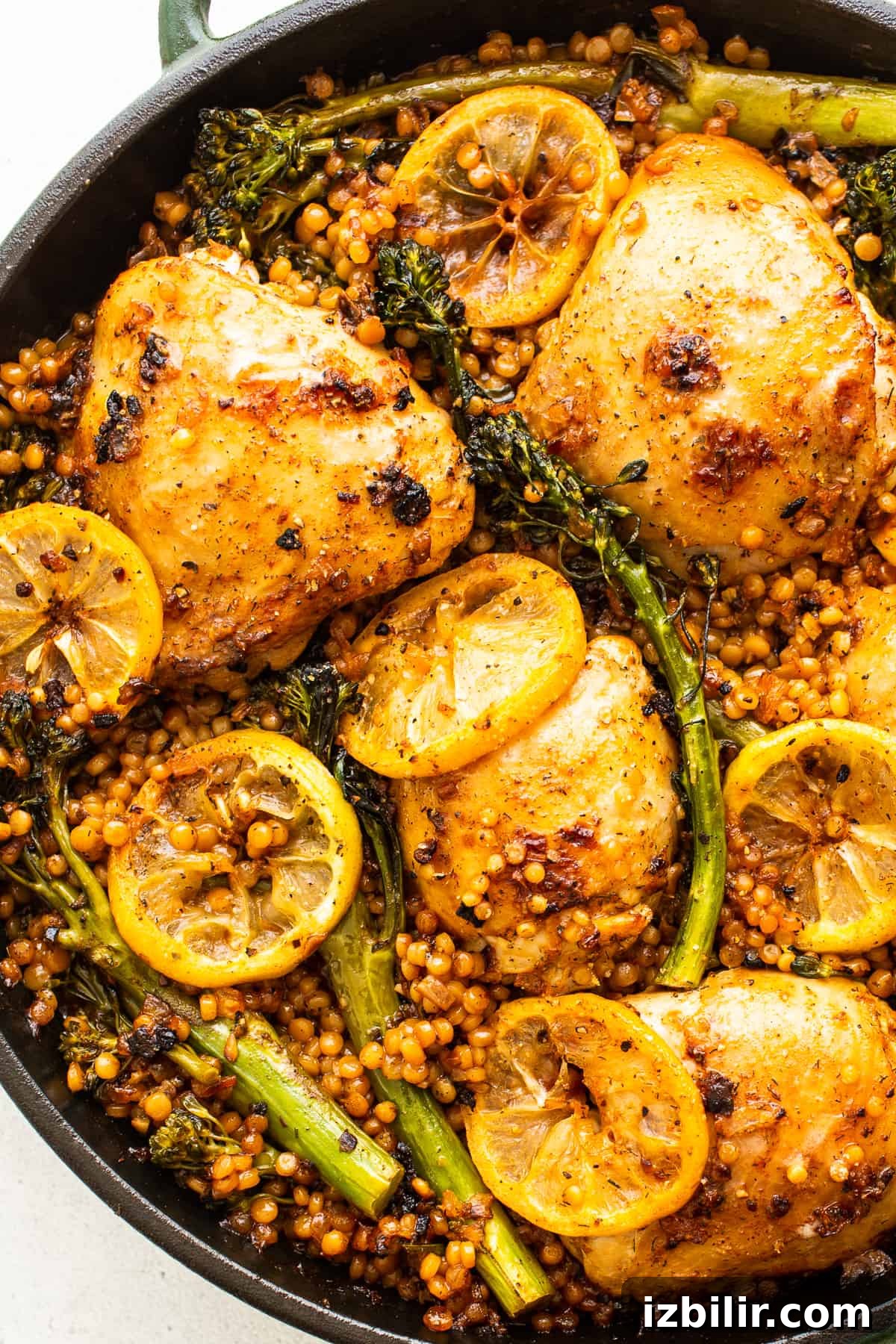 Finished lemon chicken skillet served Lemon chicken skillet with couscous and broccolini.