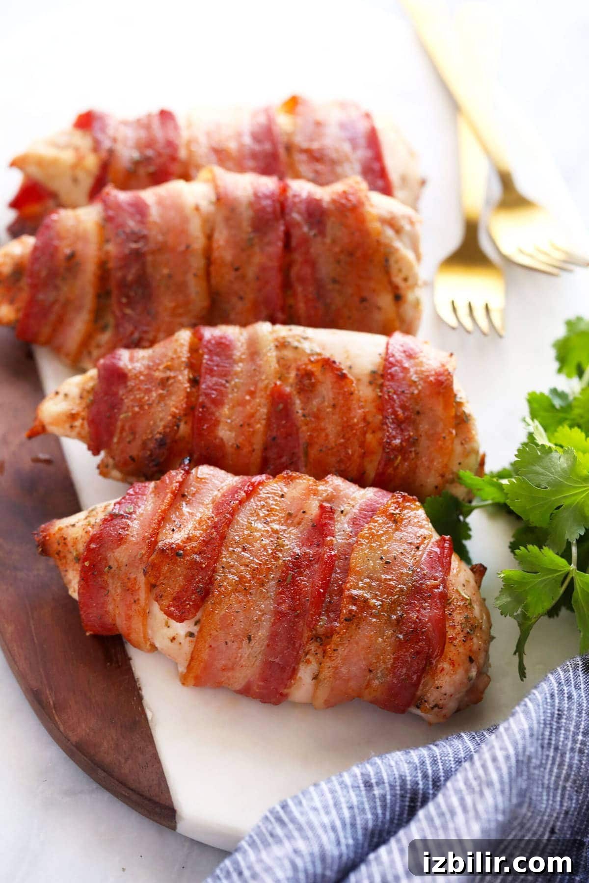 This crunchy bacon wrapped chicken salad is packed with veggies, hard boiled eggs, homemade ranch dressing, and flavorful bacon wrapped chicken! bacon wrapped chicken on cutting board