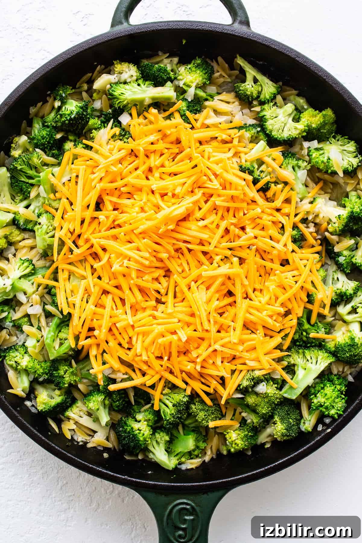 cheese on top of broccoli and orzo.