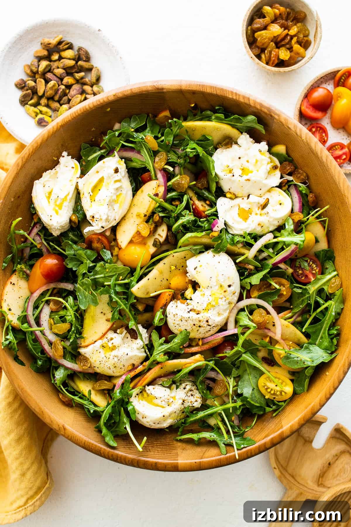 Apple burrata salad with ripped burrata on top of the salad.