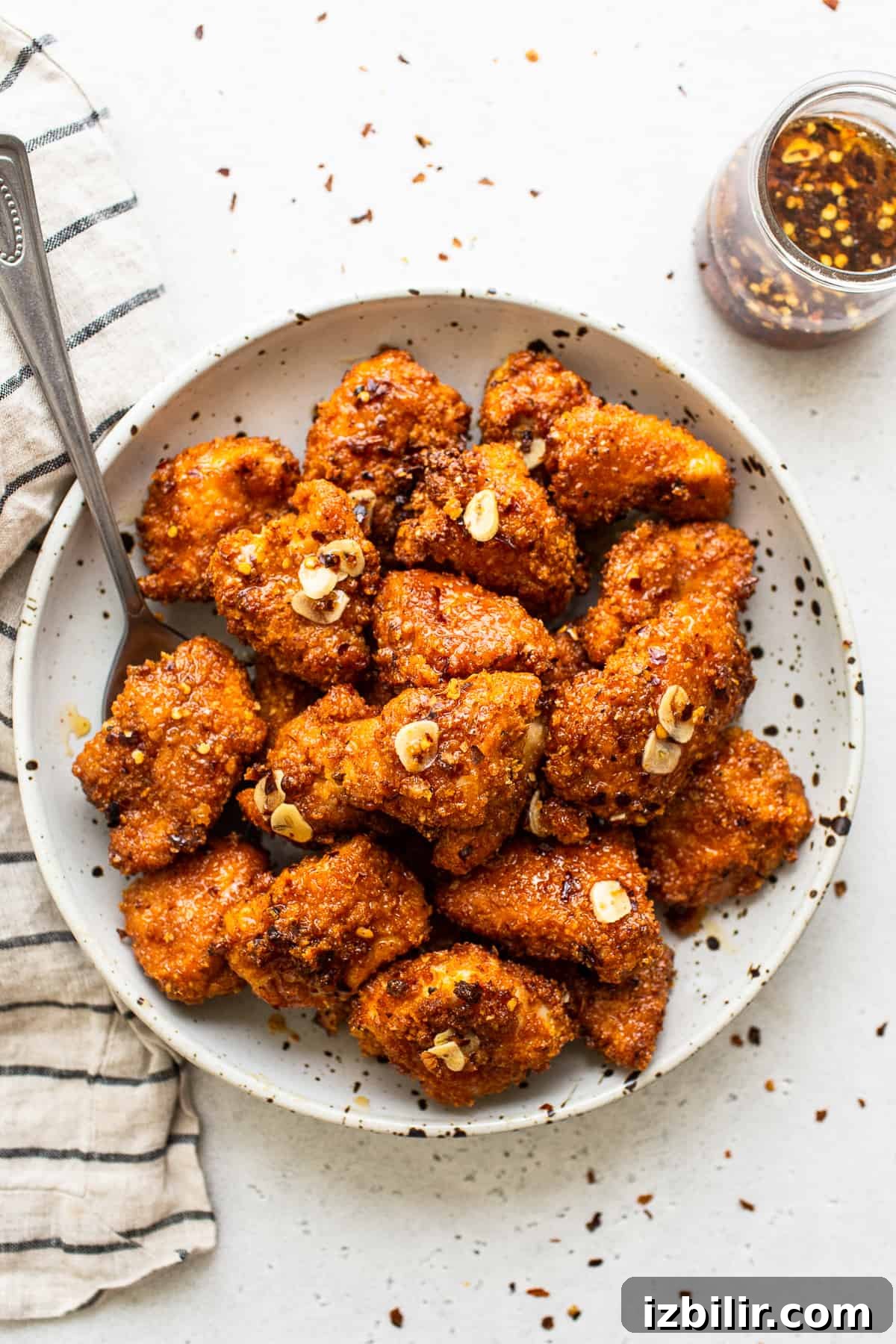 Hot honey chicken Hot honey chicken in bowl with spoon.