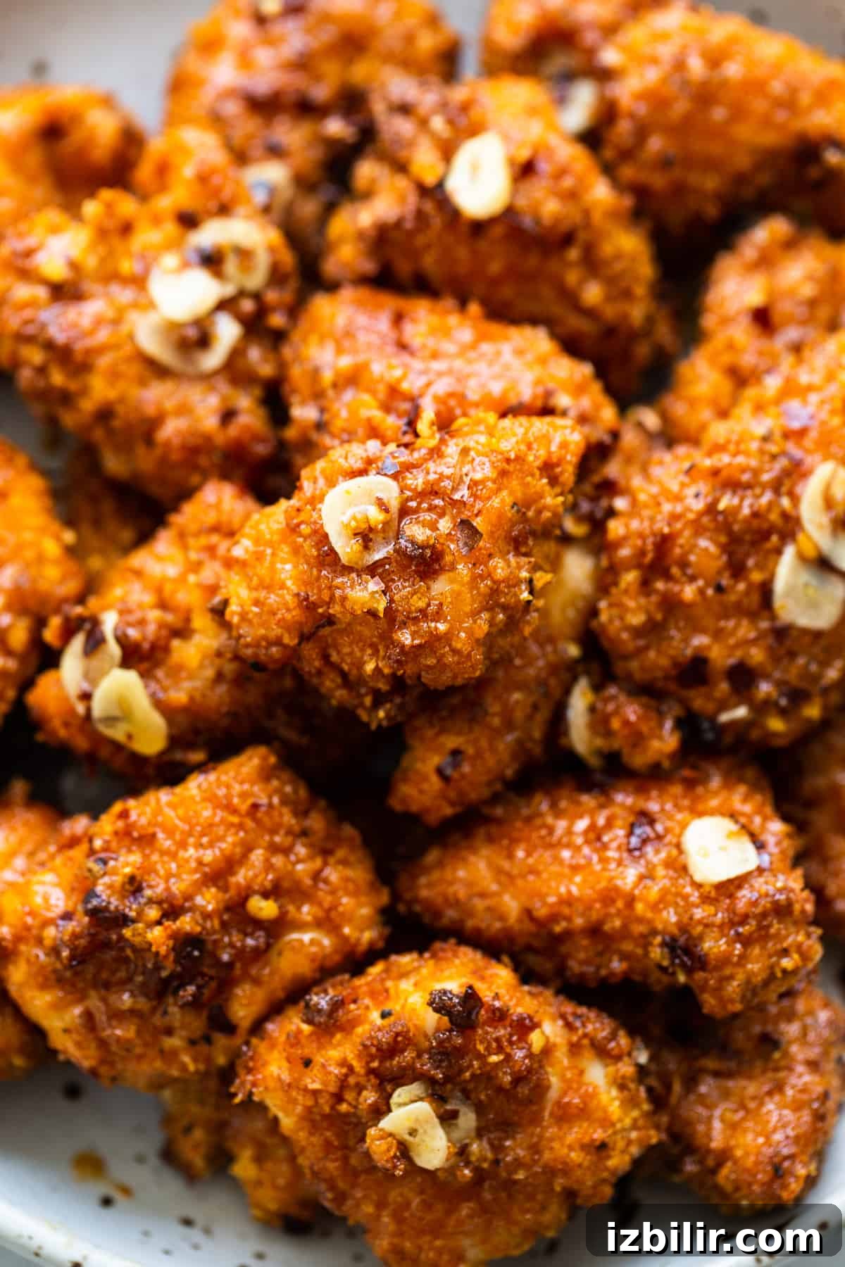 Hot honey chicken poppers Hot honey chicken poppers on plate.