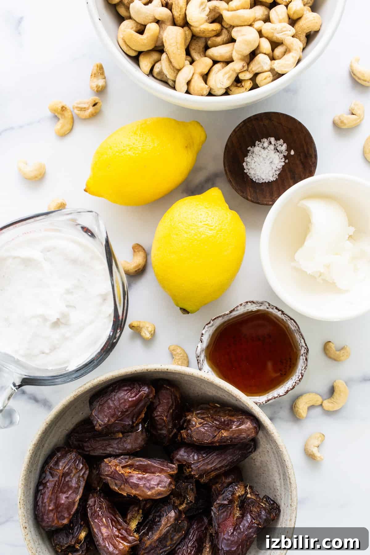 a bowl of dates, cashews, and lemons.