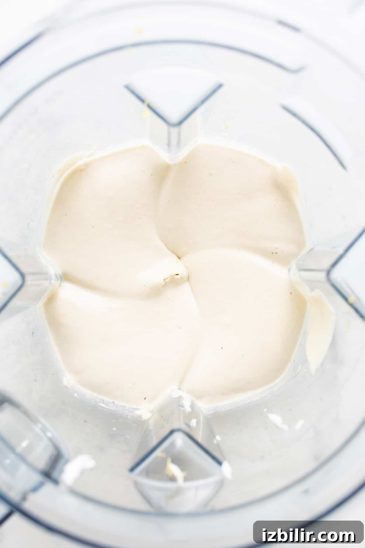 a food processor filled with cream cheese.