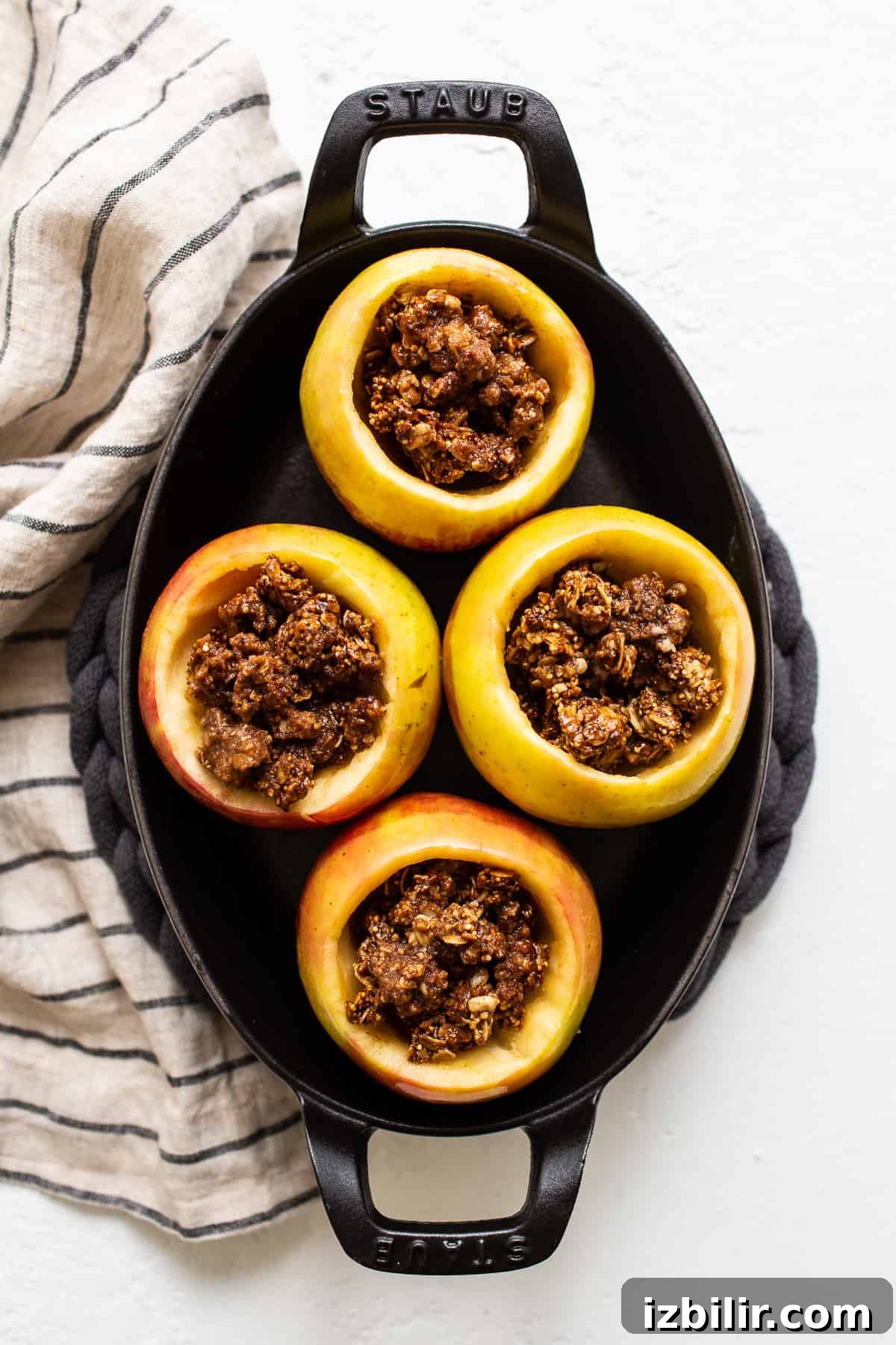 Apples filled with granola streusel. Apples filled with streusel in a baking dish.