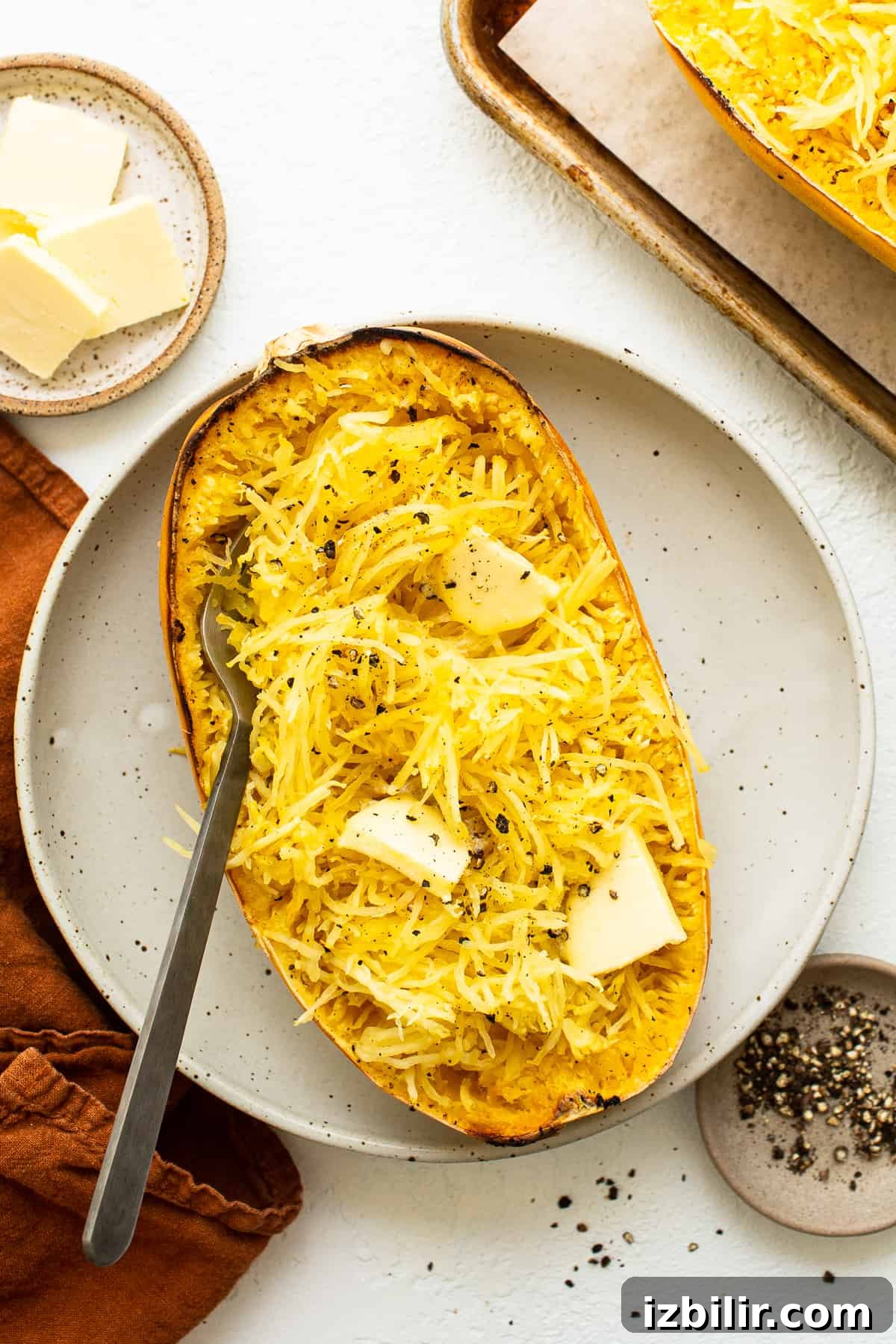 baked spaghetti squash with butter on plate.