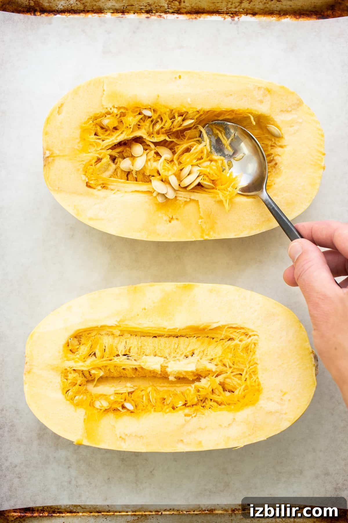 spooning out innards of squash.
