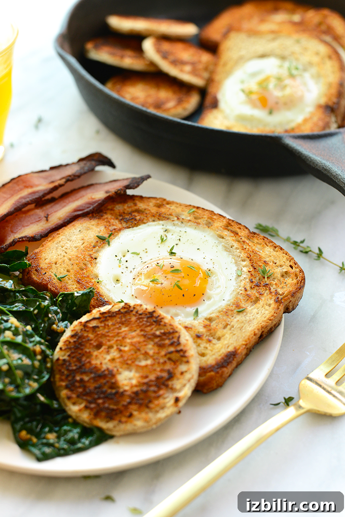 Egg in a hole served with bacon egg in a hole on plate with bacon