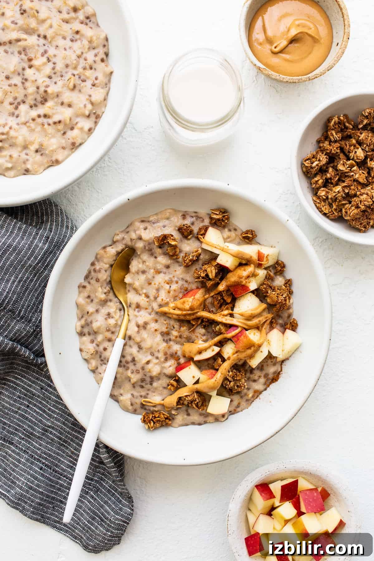 Apple cinnamon oatmeal in a bowl with a spoon.