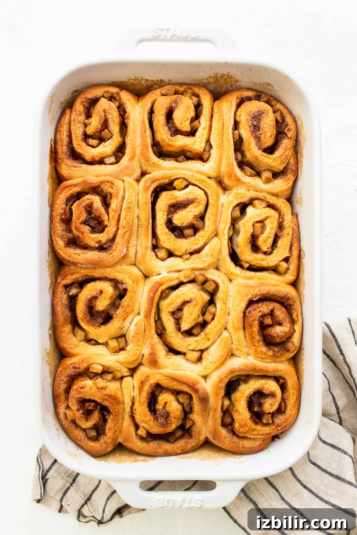Apple cinnamon rolls in a casserole dish.