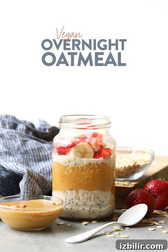 Vegan overnight oatmeal in a jar topped with strawberries and bananas.