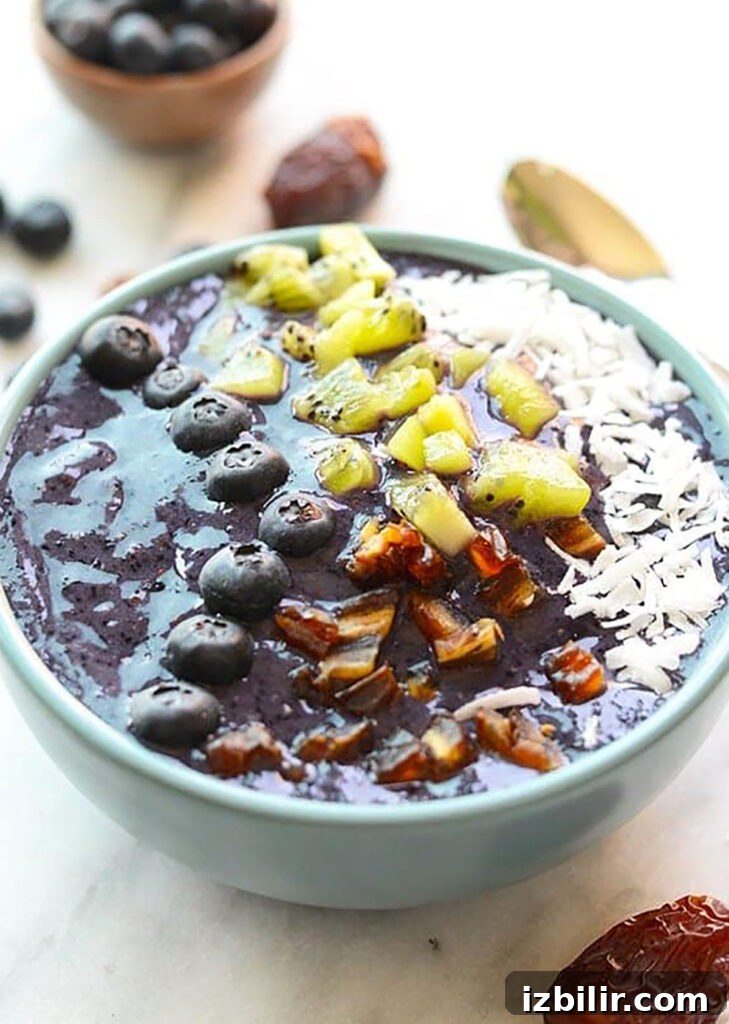 A delicious Blueberry Smoothie Bowl topped with kiwi and granola.