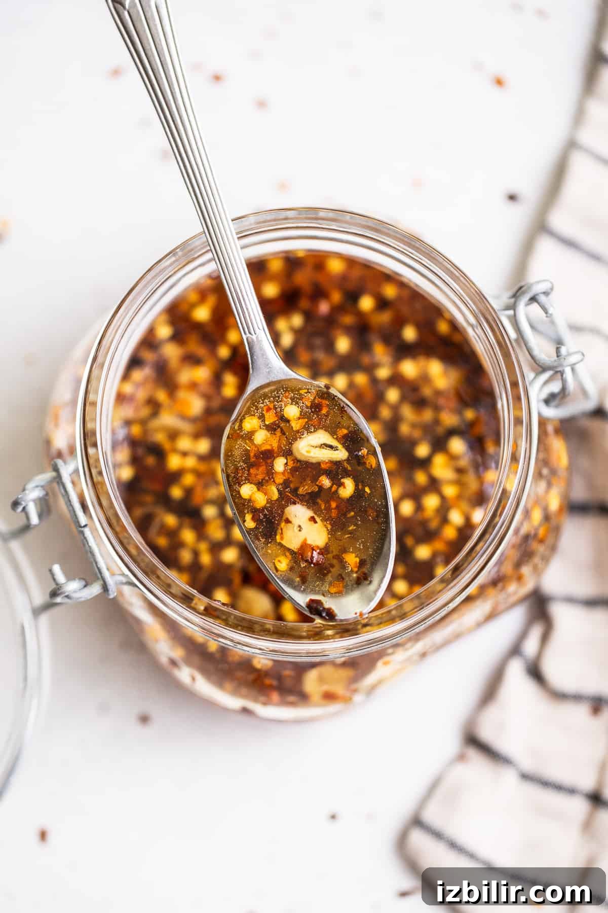 Hot honey sauce on a spoon Hot honey on a spoon.